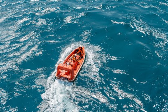 Marine crews of a pipelay barge performing man overboard emergency rescue drill at Kemaman Port Anchorage